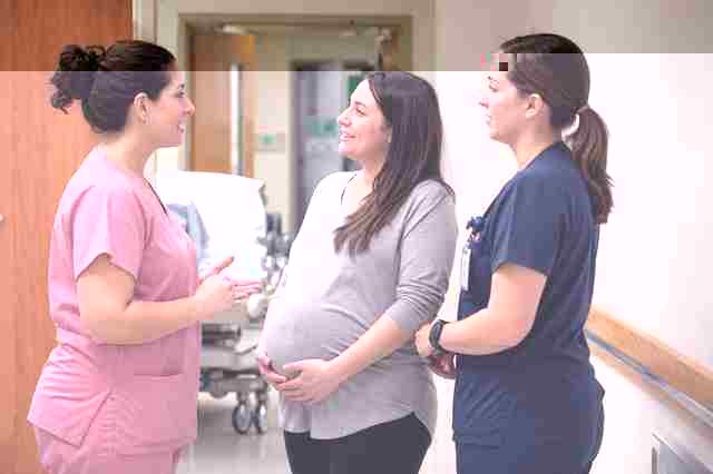 Labor and delivery surgical technologist in scrubs standing in a maternity operating room